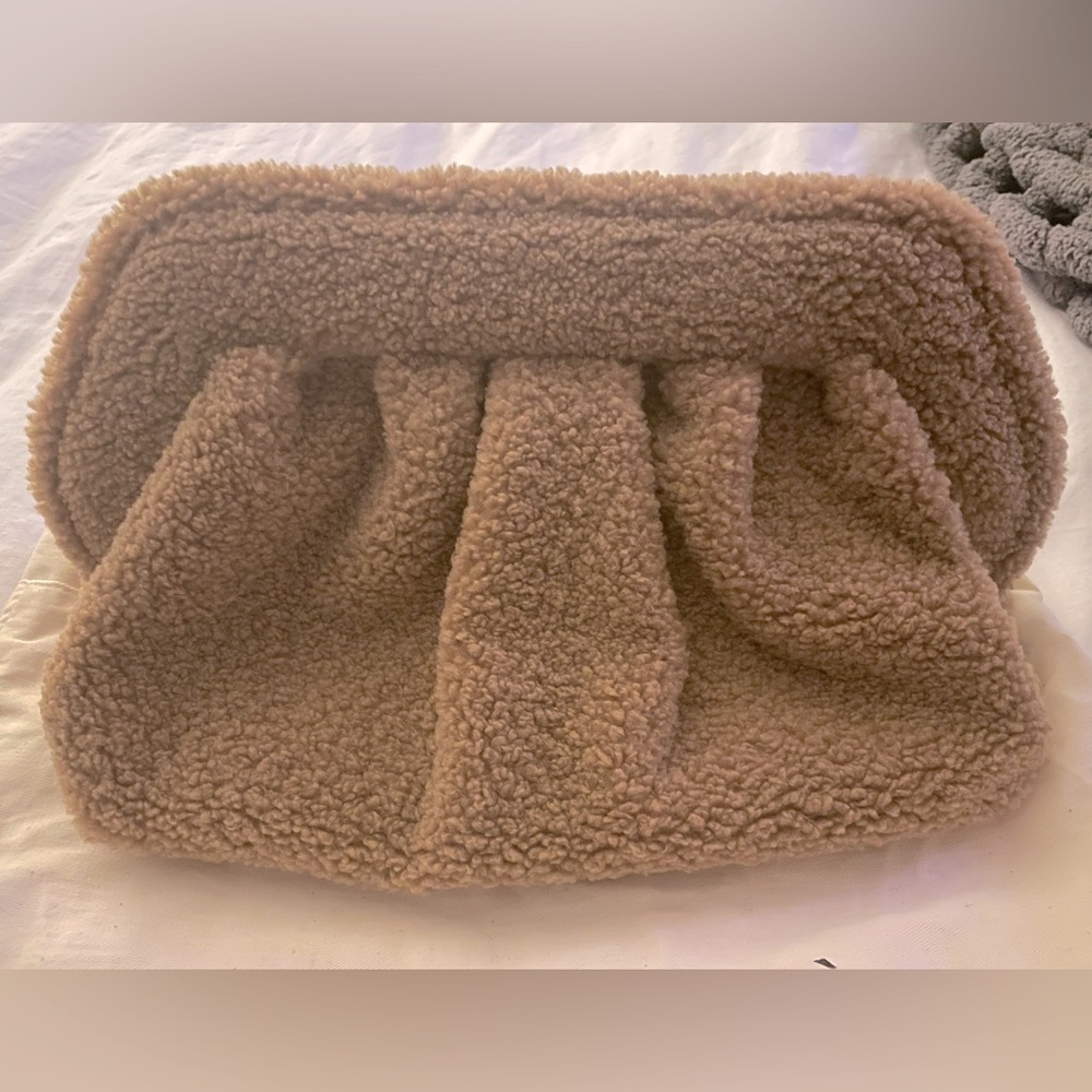 Themoire teddy clutch in camel. NWT and complete with strap and dustbag